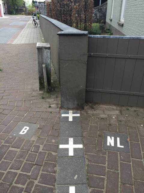 The line of border crosses running from the pavement under a garden wall and fence between two houses
