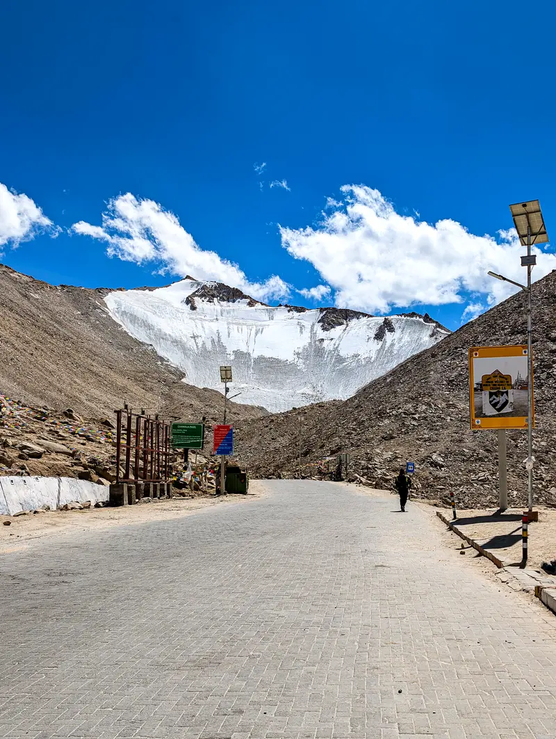 The road at Chang La beneath a snow-streaked peak