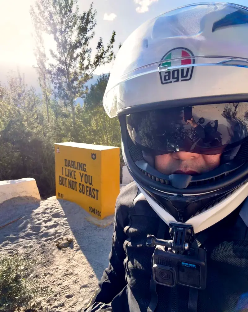 Helmet selfie in front of the yellow sign reading: Darling I like you, but not so fast