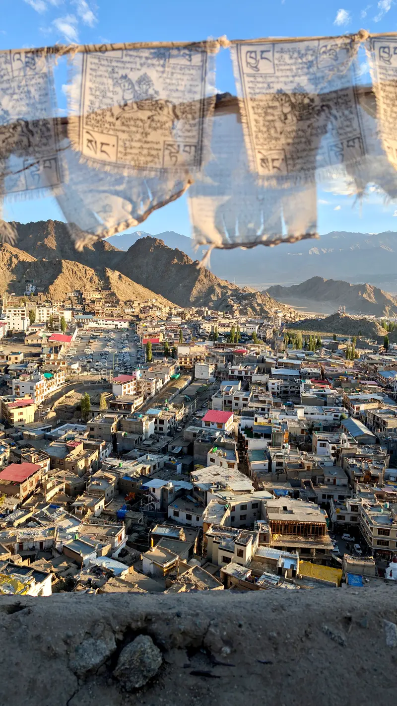 White prayer flags strung above the rooftops of Leh old town