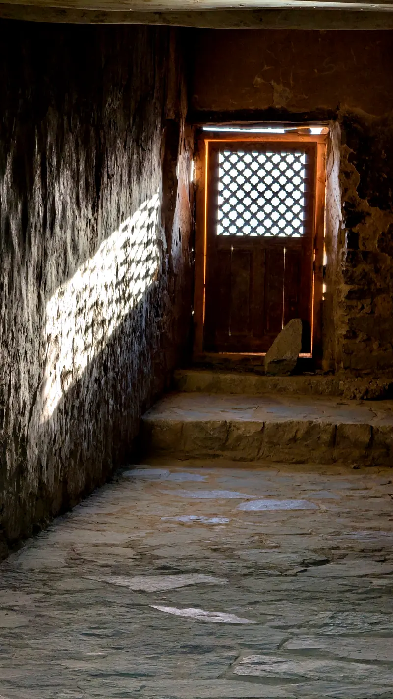 Sunlight through a latticed door into a stone corridor of Leh Palace