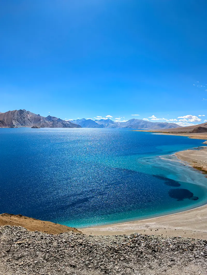 Morning at Pangong, the shallows turquoise over pale sand