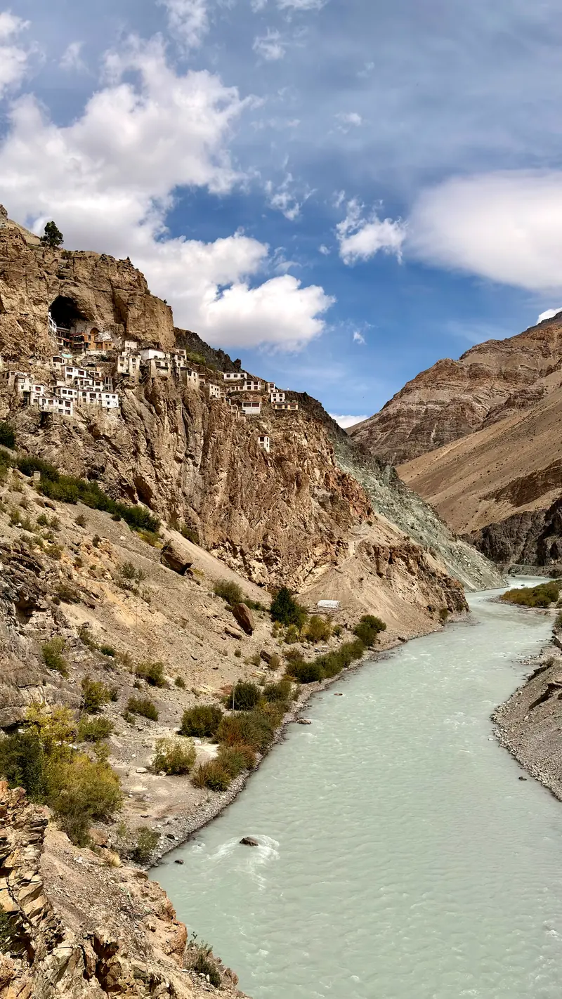 Phugtal monastery's white honeycomb of buildings above the green Tsarap river