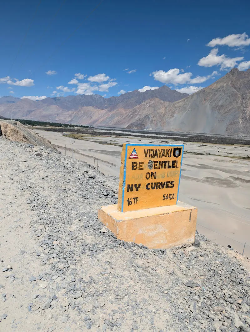 Yellow road sign reading: Be gentle on my curves